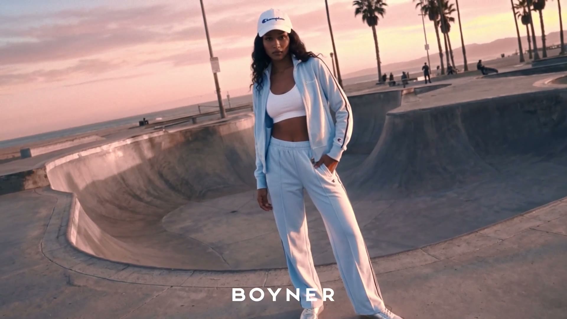 Woman in a light-blue tracksuit — palm trees