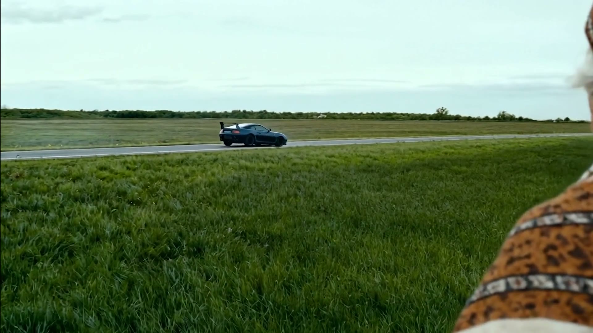 Sports car passing on the road in the distance